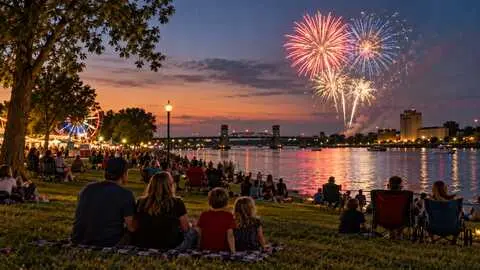 Families watching fireworks over the river in Bay City.